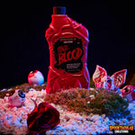 Red bottle labeled 'Sage Blood' with Halloween-themed decorations on a dark background